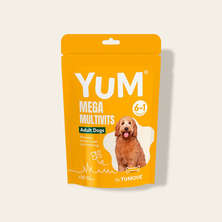 Yellow stand-up pouch of YUM Mega Multivits for adult dogs on a light beige background
